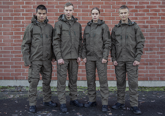 Four soldiers in a row wearing the green Nordic Combat Uniform