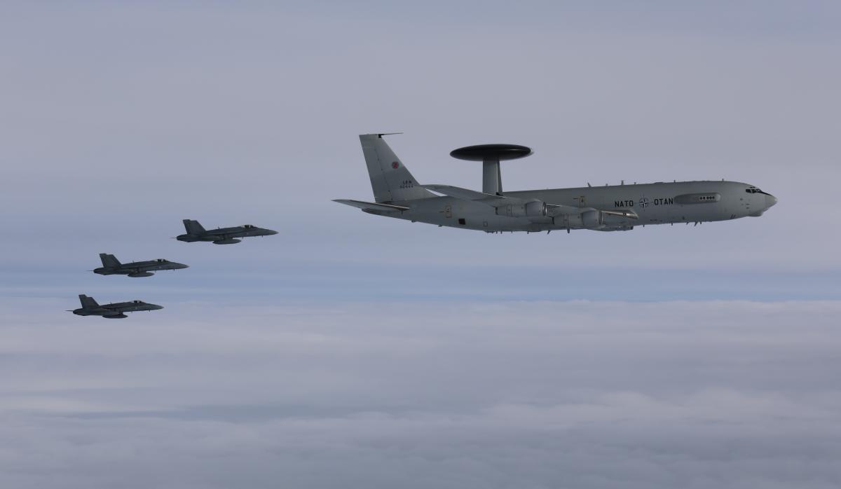 Finnish Air Force F/A-18s and a NATO E-3A Sentry AWACS.